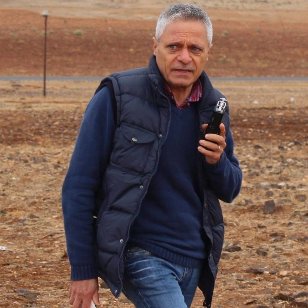 journalist mariano giustino standing with a desert in the background