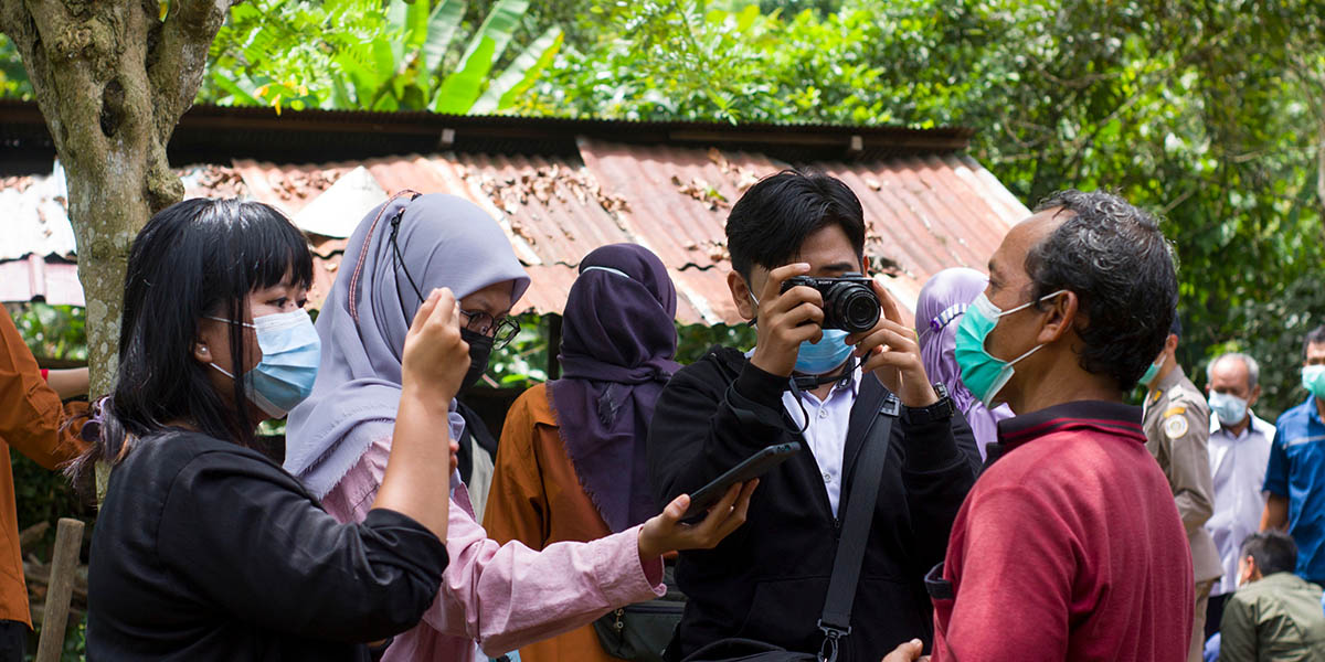 Group of journalists with cameras and smartphones in Berau, Indonesia