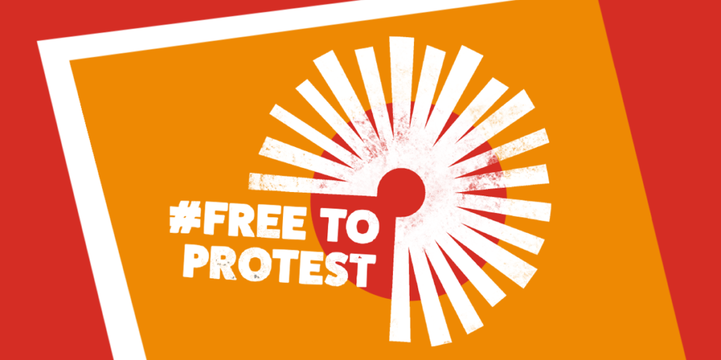 The campaign logo for free to protest with a circle with on an orange and red background