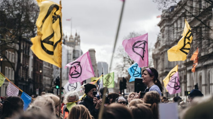 Extinction rebellion activists with flags protesting