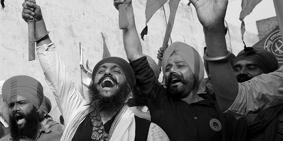 Farmers in India celebrate the government agreeing to their demands following long-running protests. Singhu border protest site, near the Delhi-Haryana border