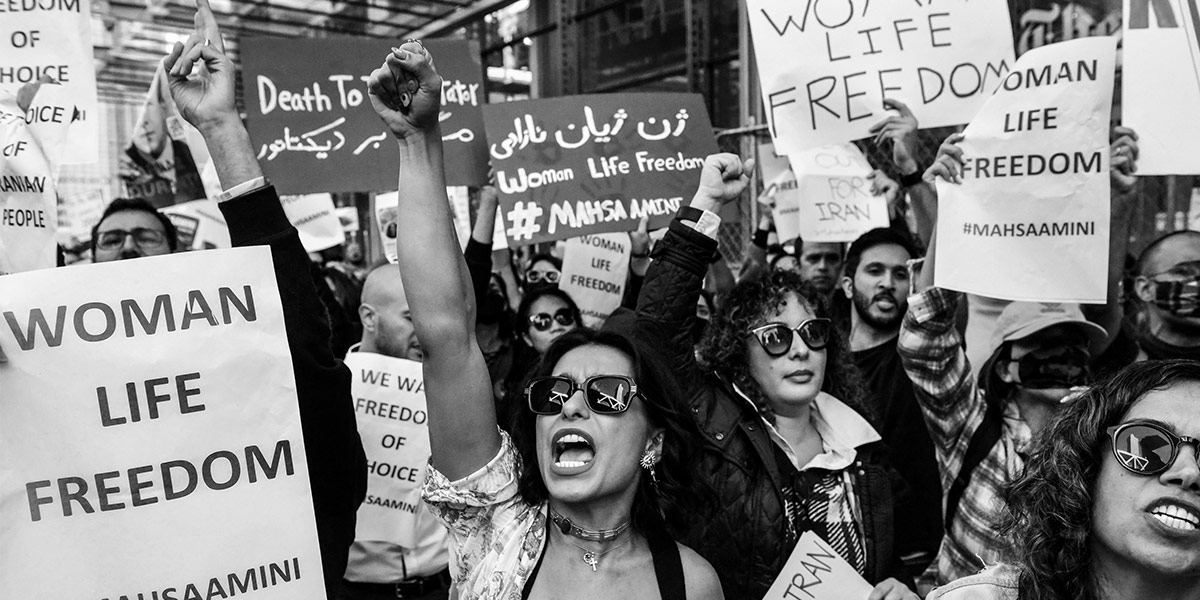 People protest in Iran with signs that say 'Woman Life Freedom'